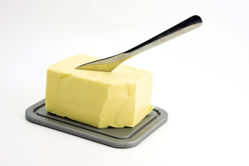 butter on a dish with knife. shutterstock photo.